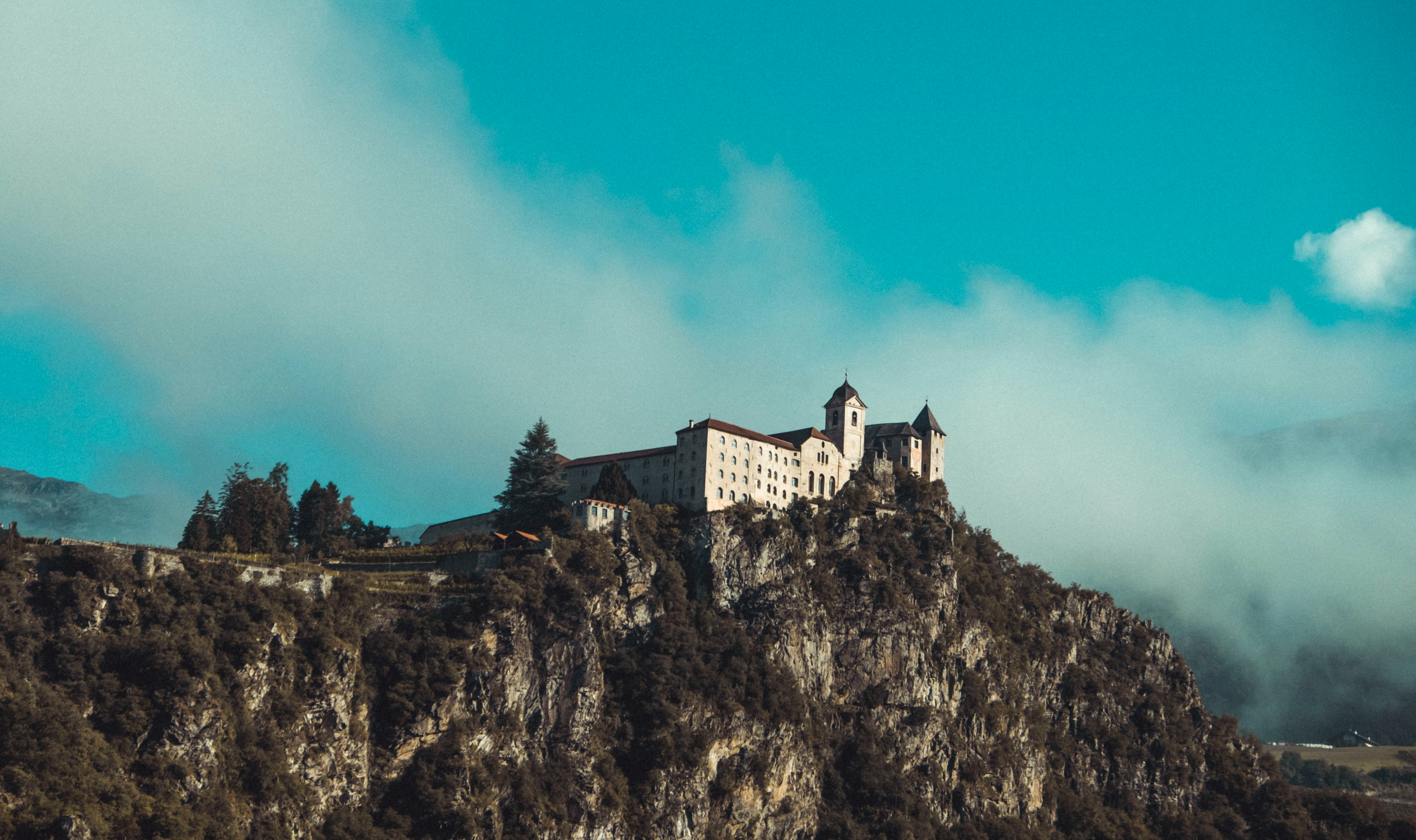 white concrete building on top of mountain